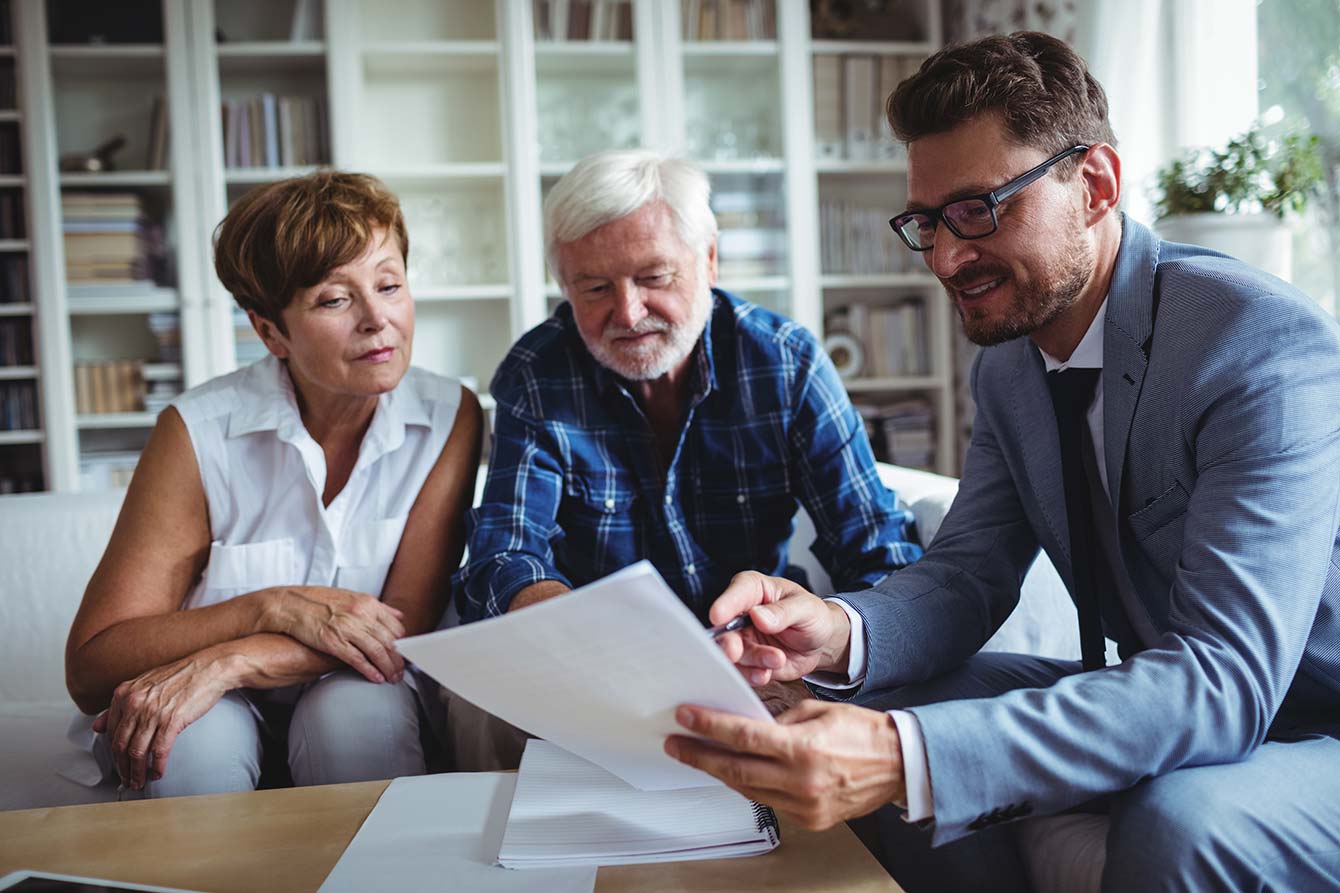 Senior couple planning their retirement with financial advisor