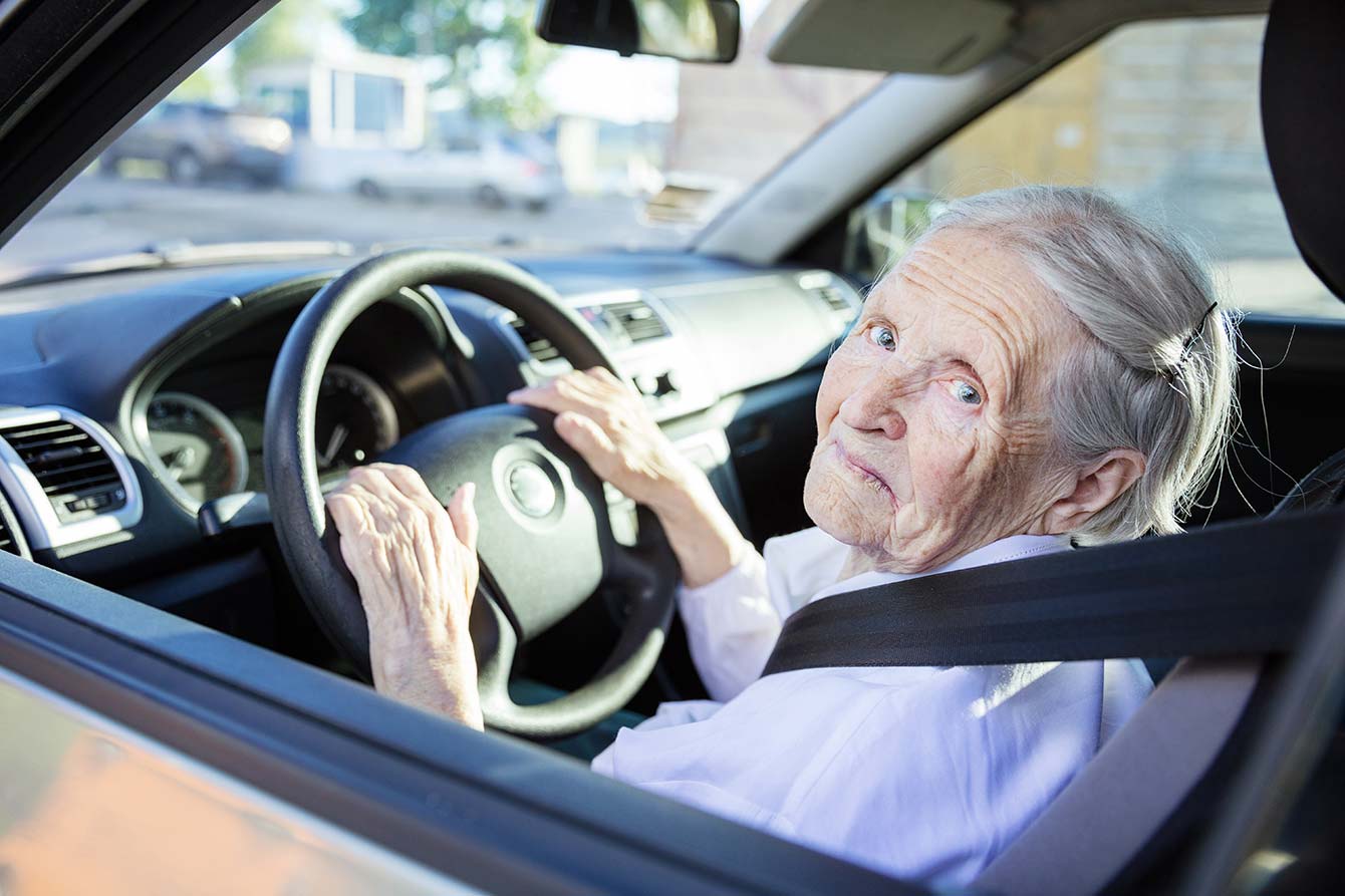 Elderly woman drives her car