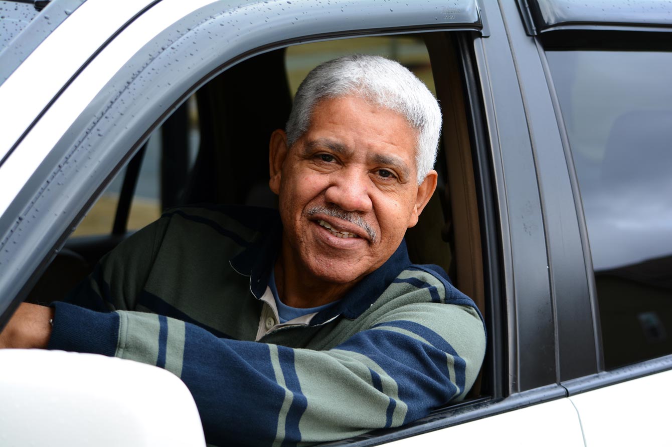 Senior latino man driving his car