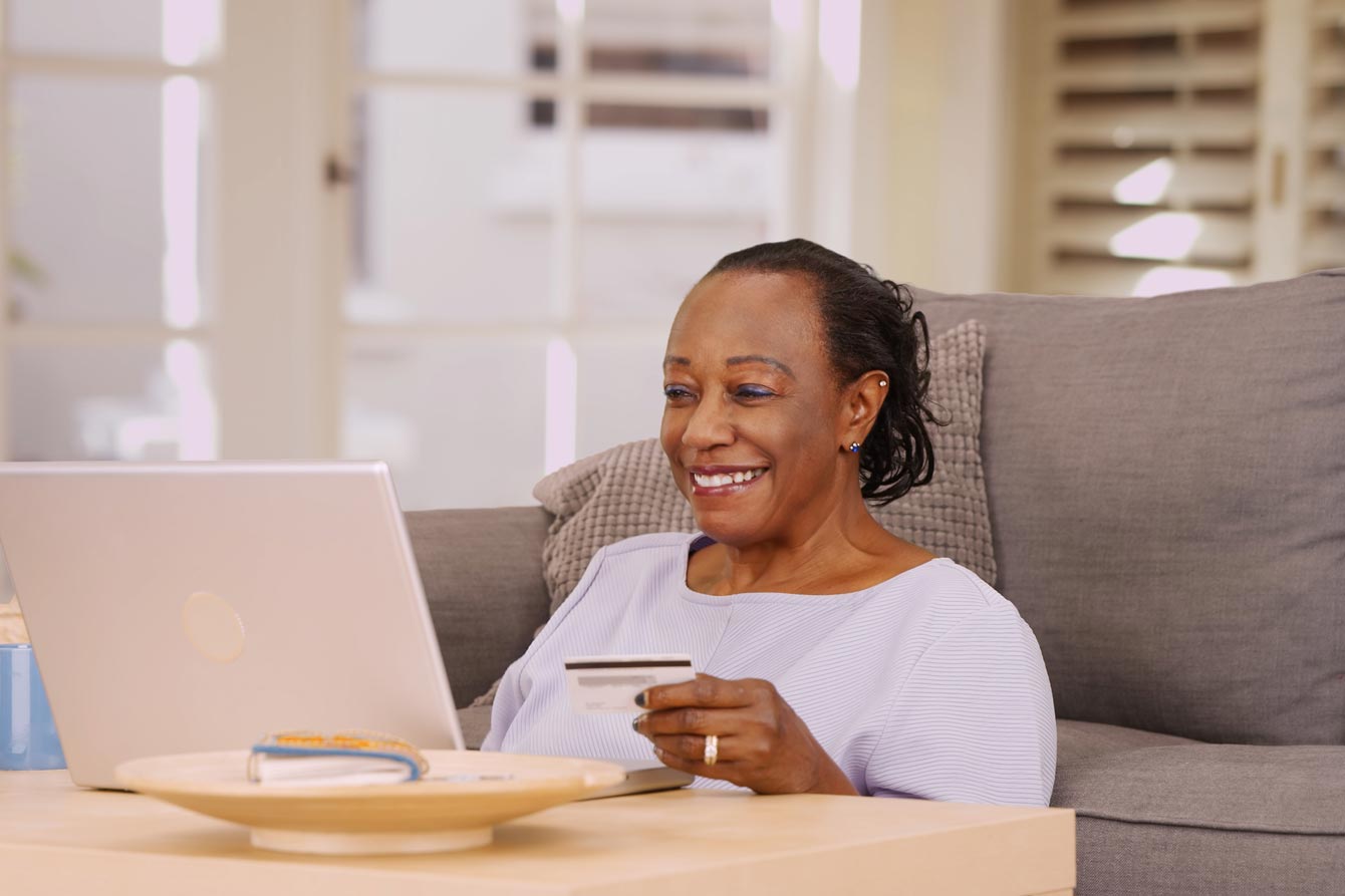 Smiling older African American woman holding a credit card