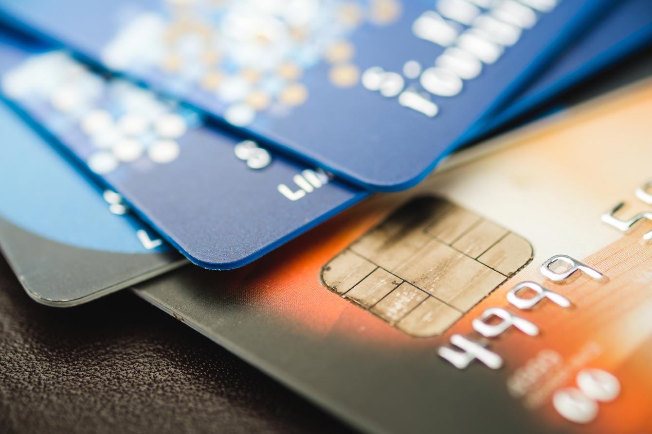 A stack of blue and brown credit cards