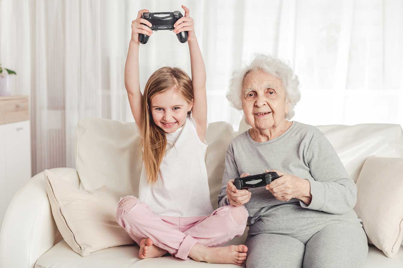 Grandmother and grand daughter play video games
