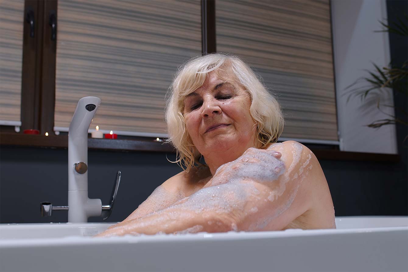 Senior women in bathtub with bubbles