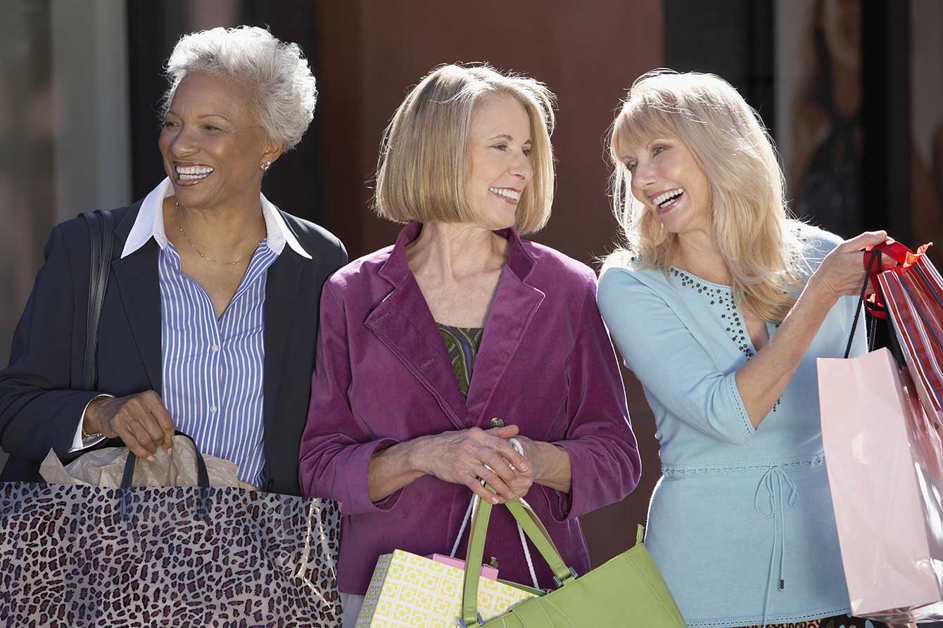 Happy multiethnic female friends with shopping bags