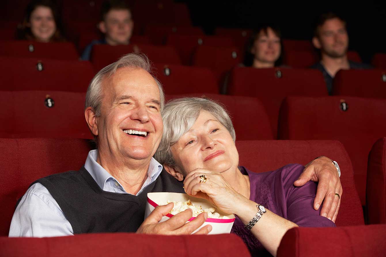 Senior couple watching movie in movie theater
