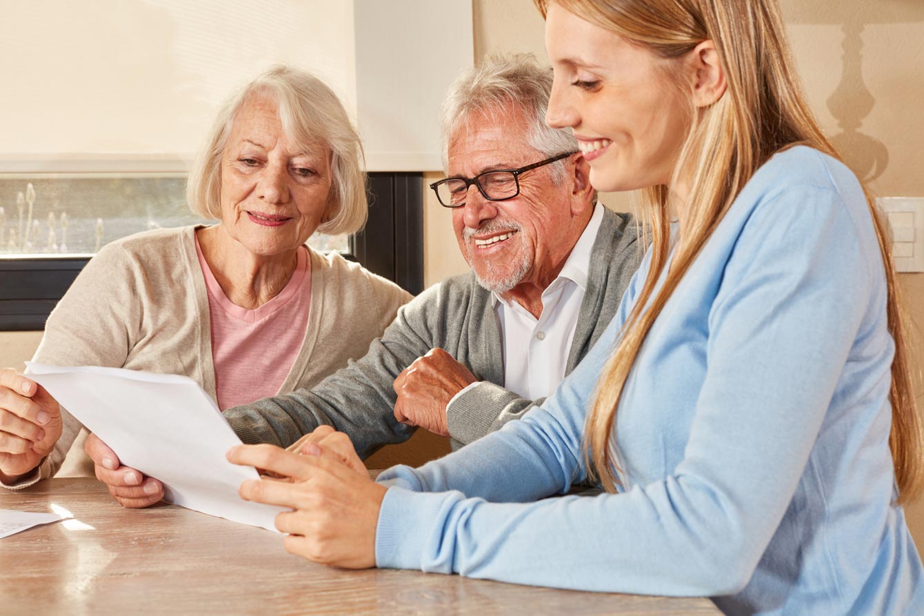 Senior married couple with a female credit counselor