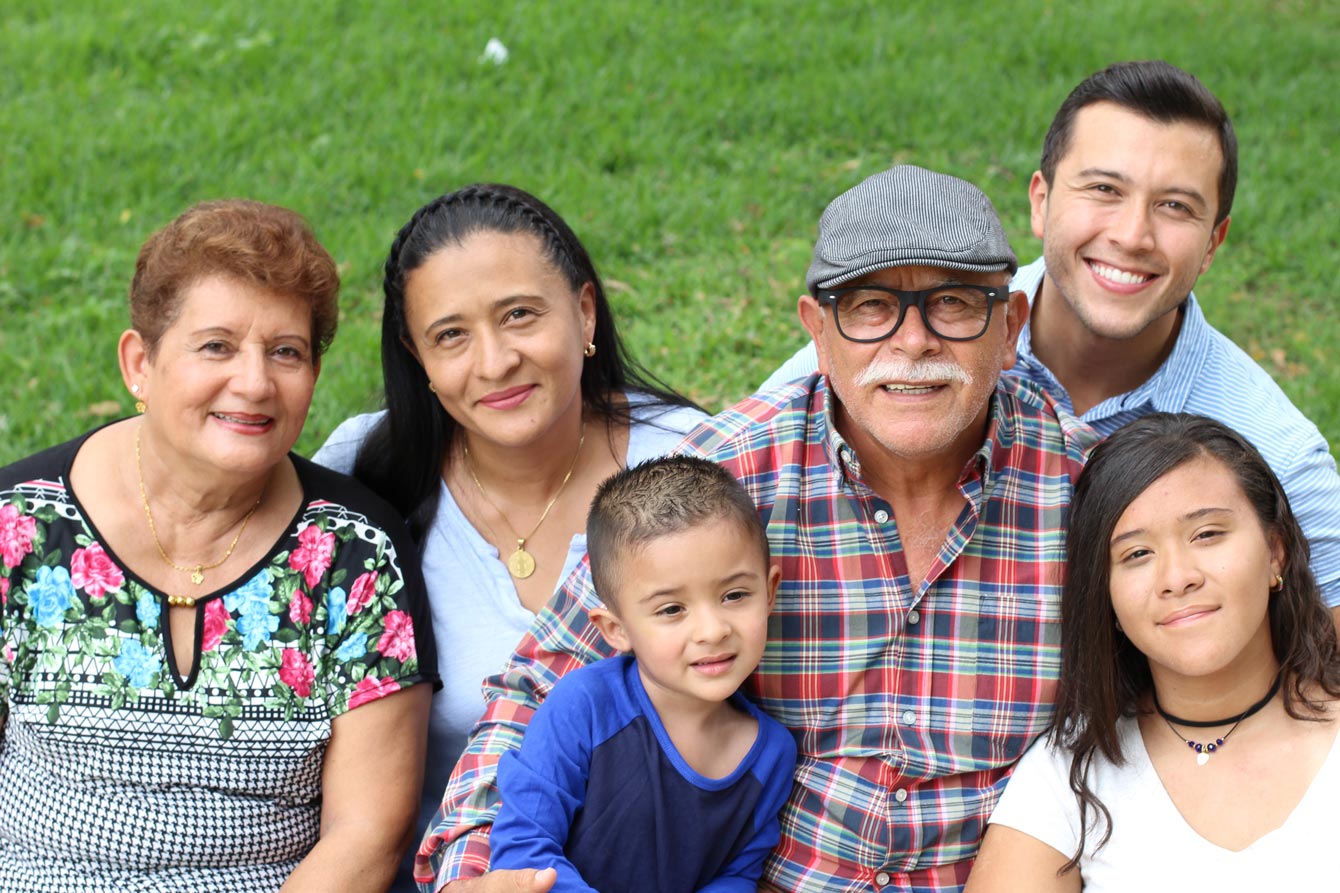 Hispanic grandparents with family in park