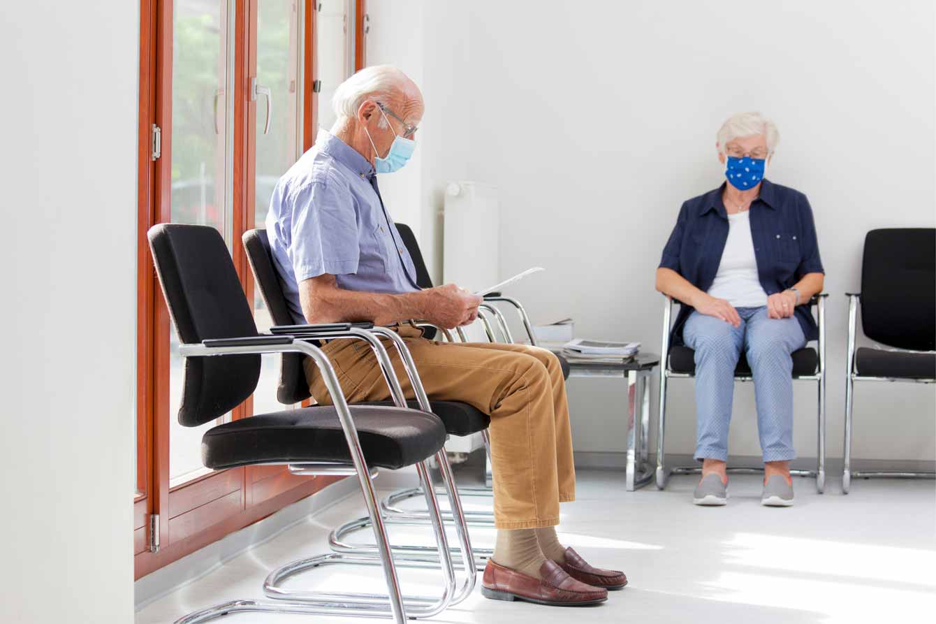 Senior man and woman in doctor's waiting room