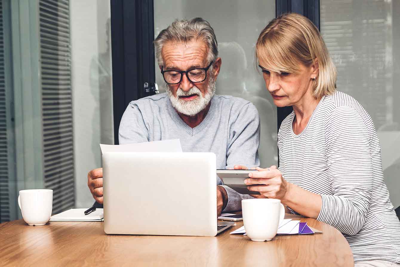 Stressed senior couple calculating their bills