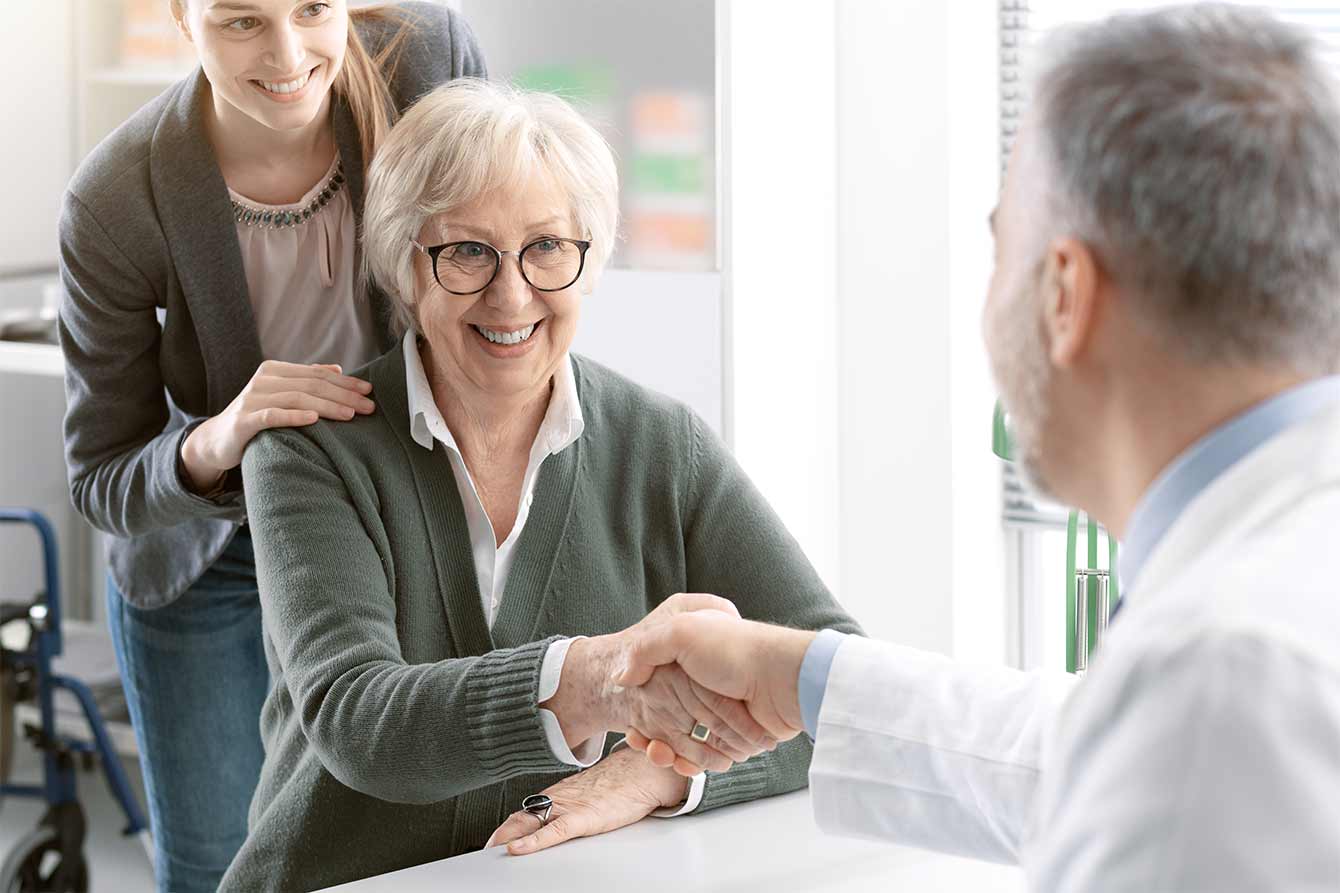 Doctor shaking hands with a senior patient