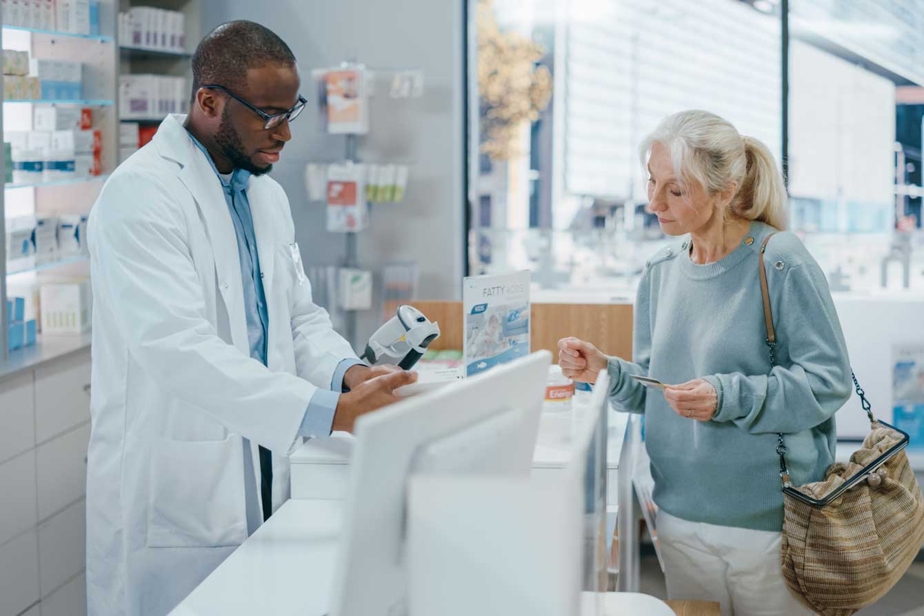 senior woman checking out her prescription purchases in a drugstore
