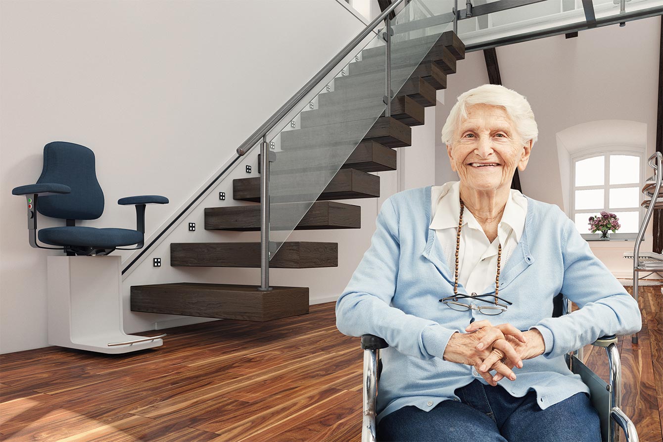 Senior woman at home in front of a high-tech stair lift