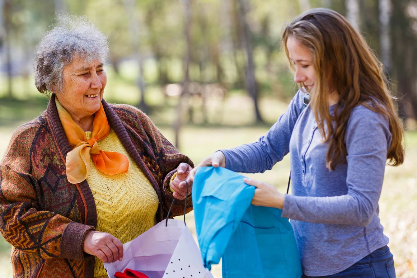 senior woman receives her shopping bag from her shopper