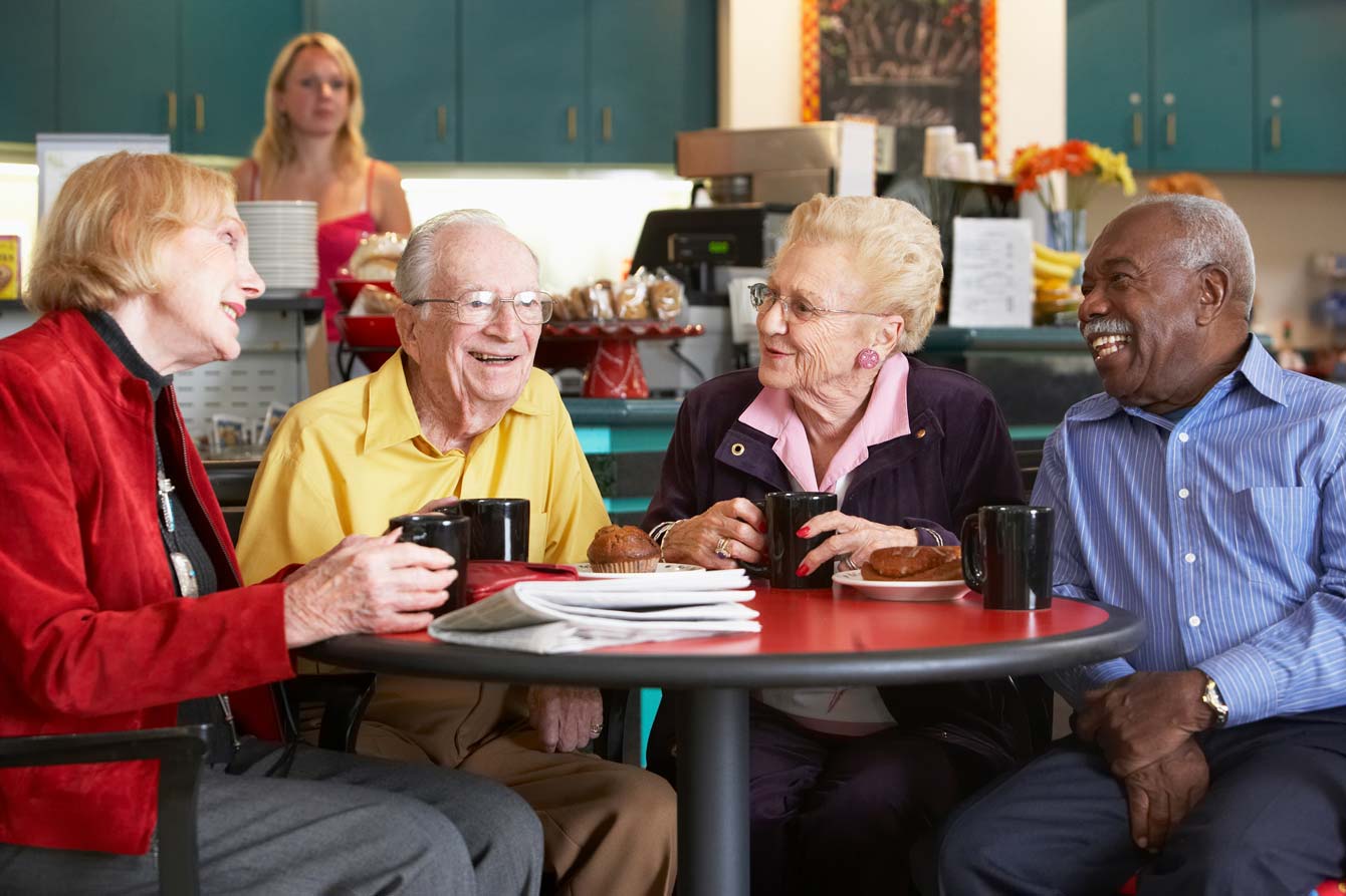 group of senior adults having breakfast in a diner near their housing
