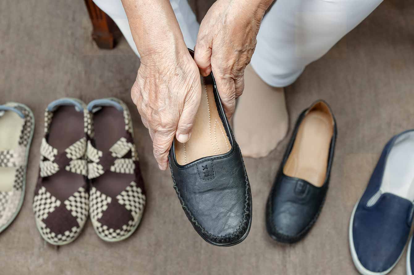 An older woman writes in a notebook