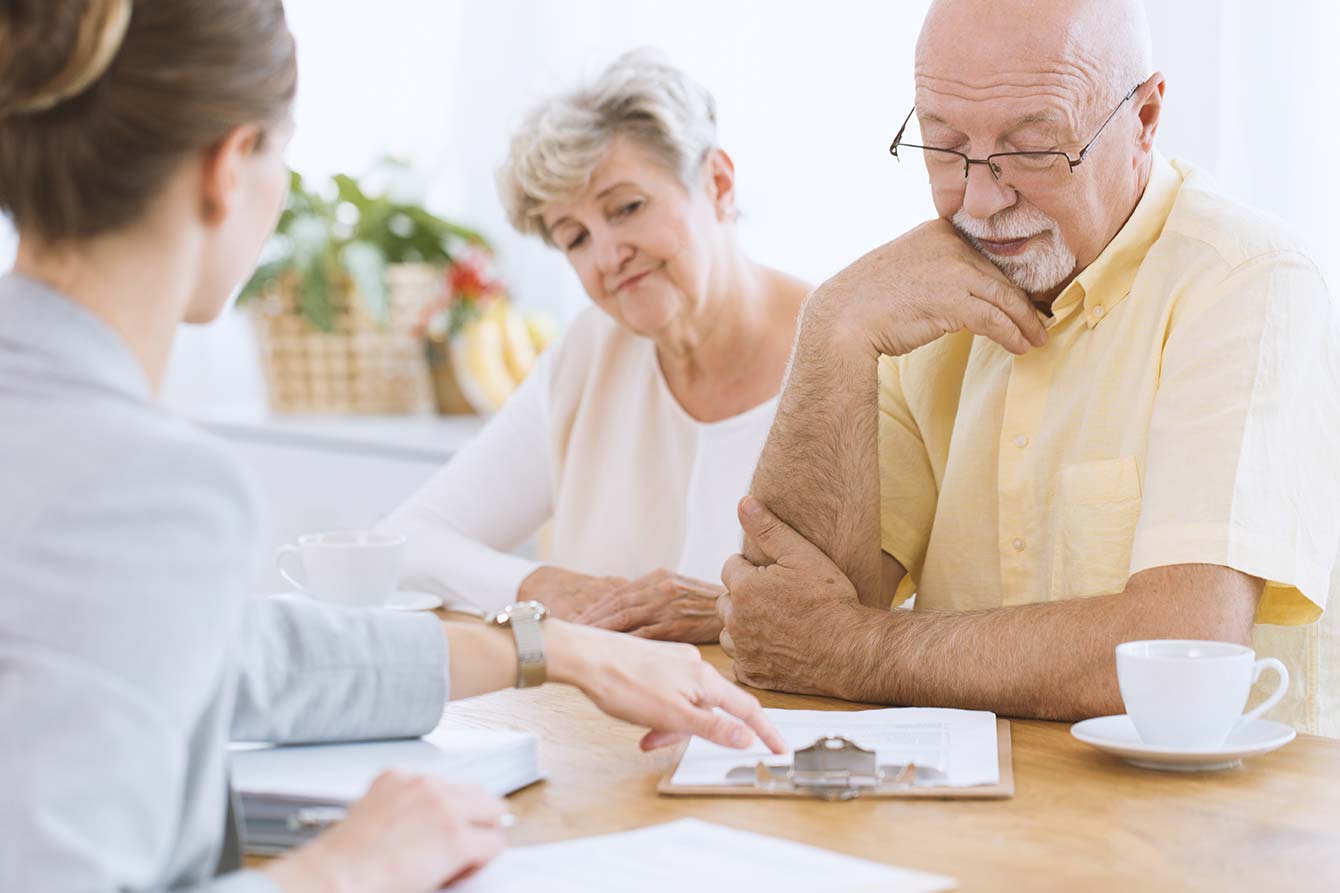 A senior couple review a life insurance application