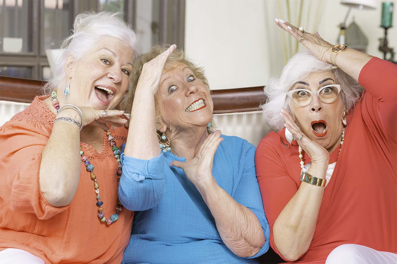 Three female seniors make goofy poses