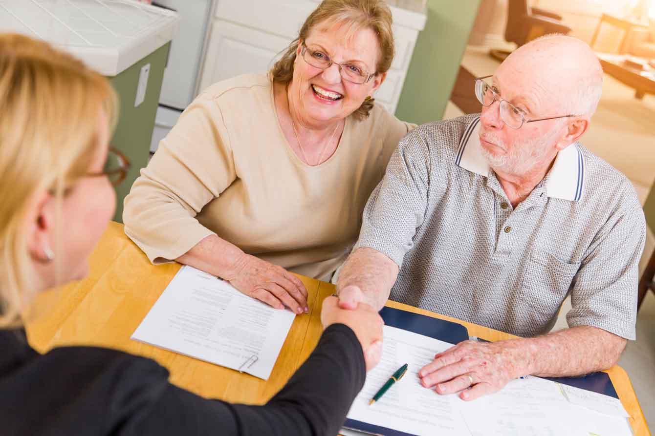 A senior couple meets a lawyer helping them prepare their will and trust
