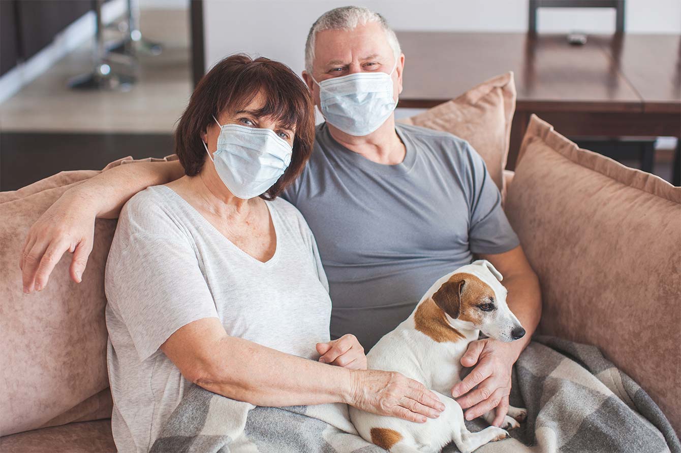 Elderly couple in medical masks during the coronavirus pandemic