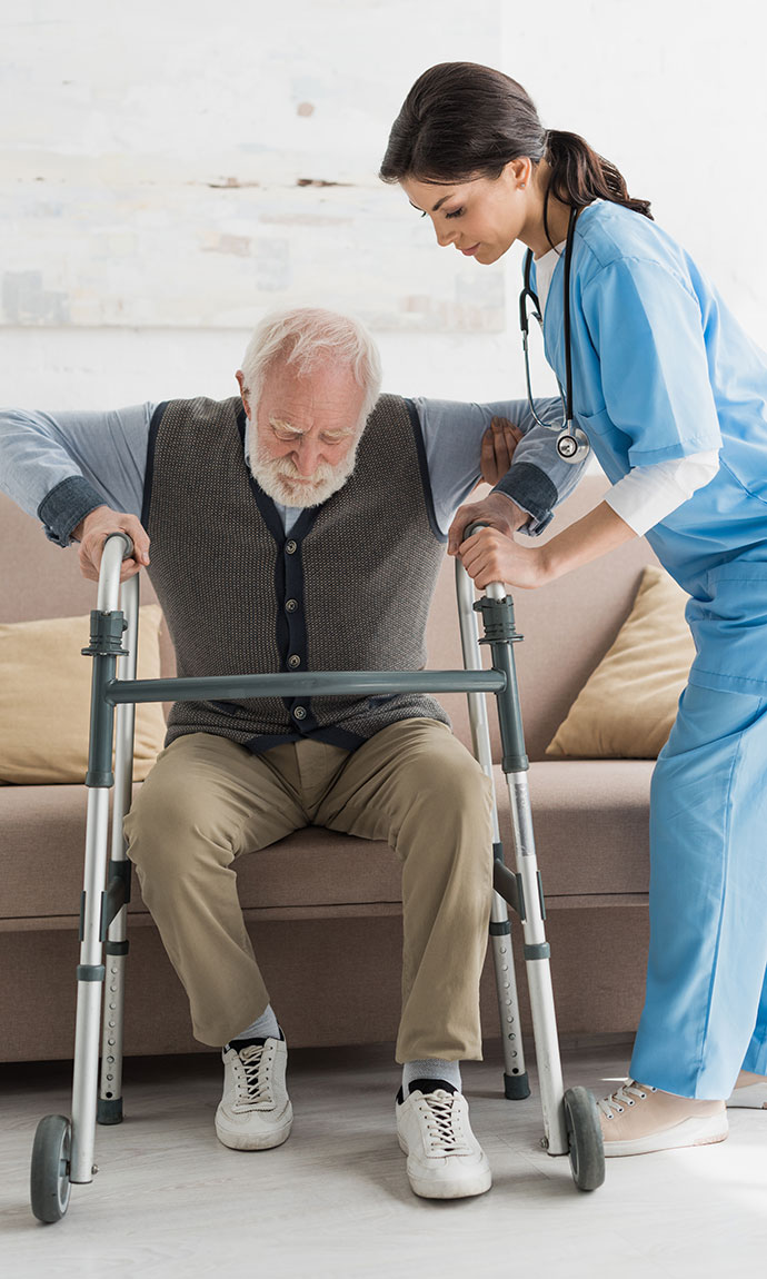 home care worker helping senior get up