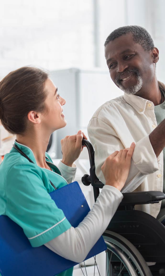 nurse with senior man in nursing home