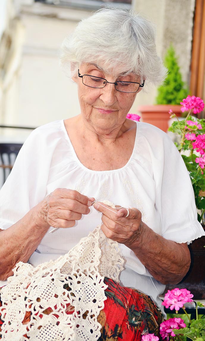 female senior knitting
