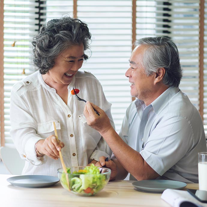 senior couple sharing a salad