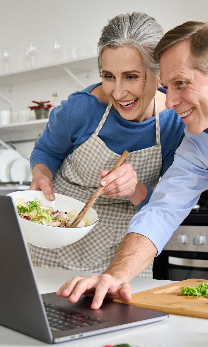 senior couple happy in online cooking class