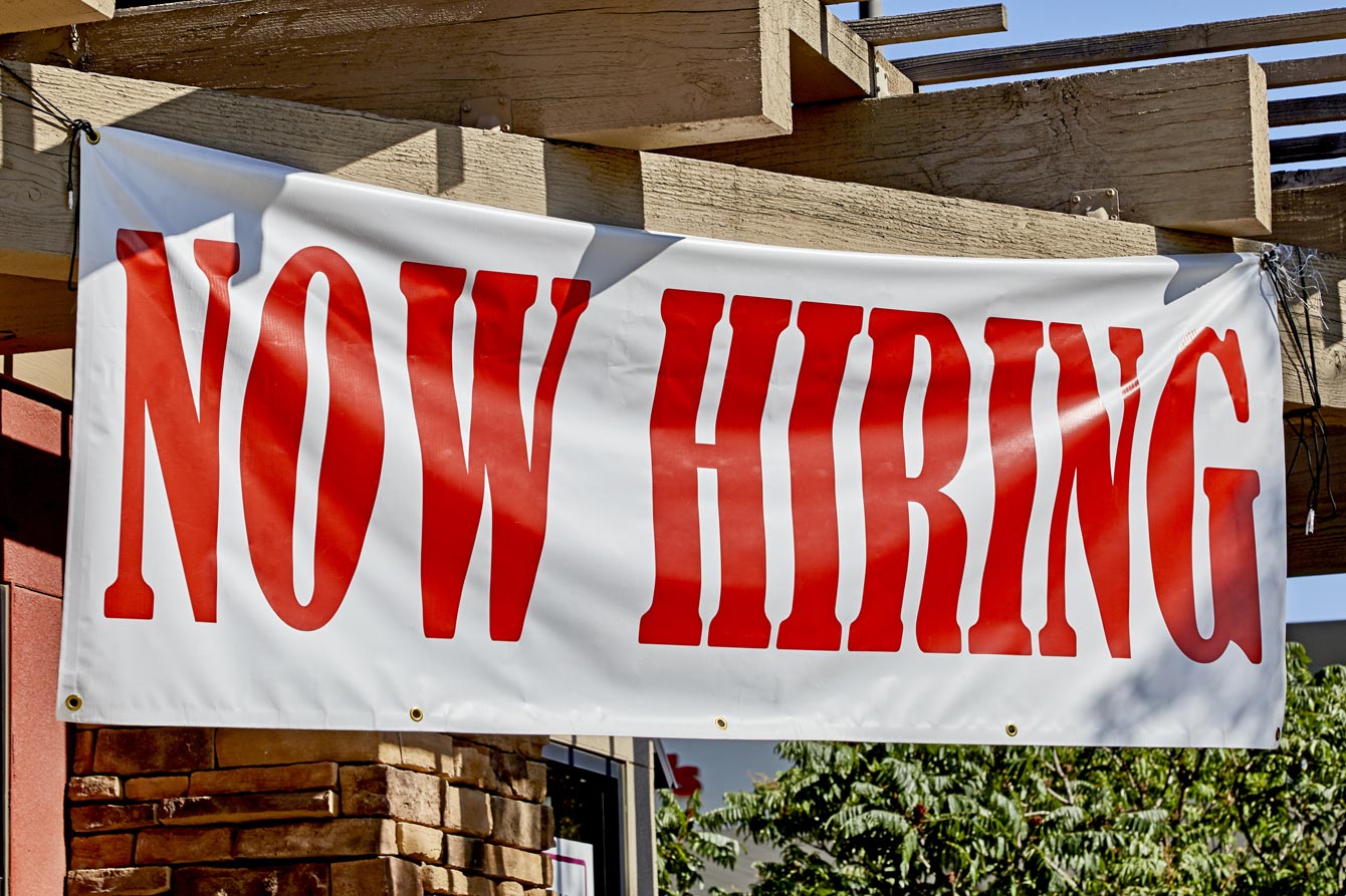 Now Hiring banner in large red letters