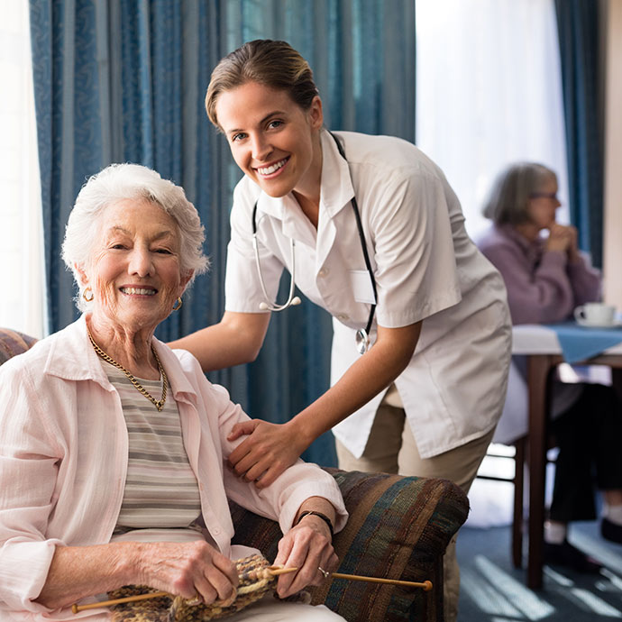 senior in assisted living with nurse