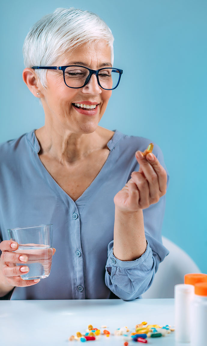 senior woman looking at a vitamin
